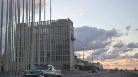 An American classic car passes next to the building of the US Interests Section in Havana, Cuba, Dec. 17, 2014.