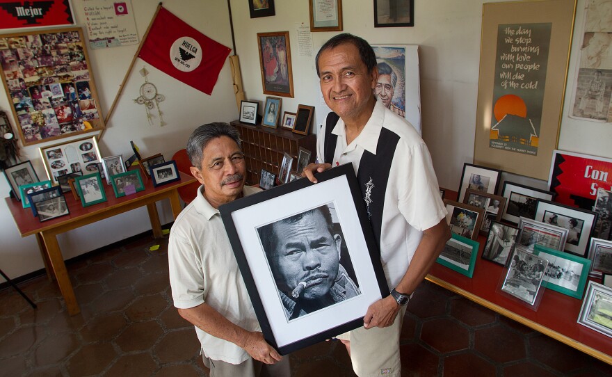 Roger Gadiano (left) and Alex Edillor hold a photo of grape strike leader Larry Itliong, whom they respectfully refer to as "The Man." Itliong convinced Filipino grape worker to go on strike in 1965, a step that set in motion the Farmworker Movement.