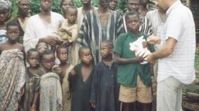 Oceanside resident Allan Paloutzian was a Peace Corps volunteer in Nigeria from 1964 to 1966.  In this photograph Paloutzian (right) presents a rabbit to villagers as part of a project to increase the amount of protein people ate.   
