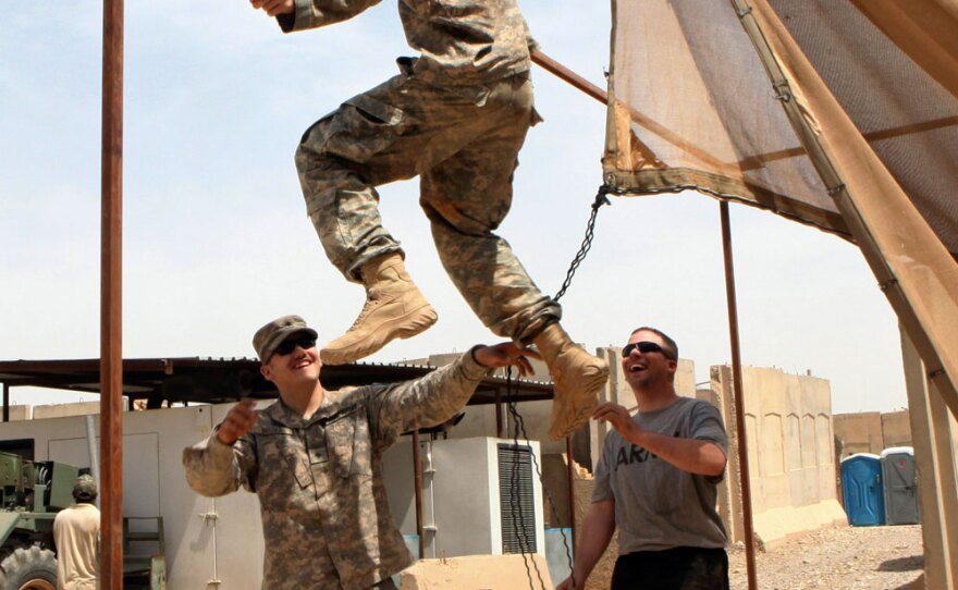 U.S. soldiers work to strike their camp as they prepare to leave their base.