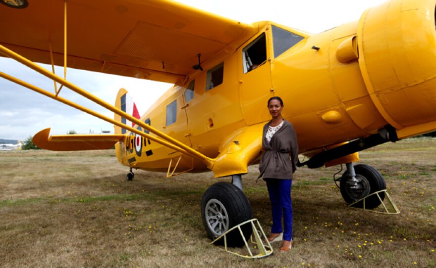 Detective Kaiama Glover in front of a Norseman bush plane, the same kind Glenn Miller boarded before his mysterious disappearance. Can this plane unlock the secret of what happened to him?