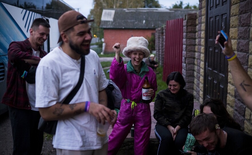 Volunteers drink beer and dance to a song by The Lonely Island comedy group at the end of the day in Kolychivka.