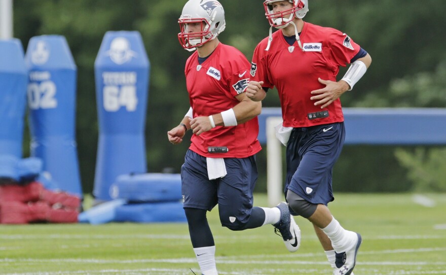 Tebow (left) runs with Patriots quarterback Tom Brady during practice. Tebow may not start games next season, but he will get something more valuable by being on the team.