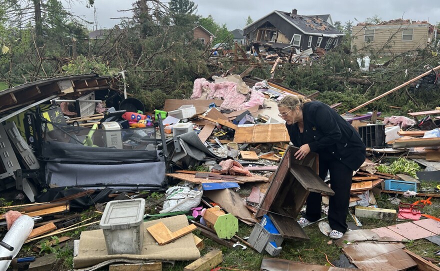 Theresa Haske sorts through debris from what was her garage after a tornado tore through Gaylord, Mich., on Friday. At least two people were killed.