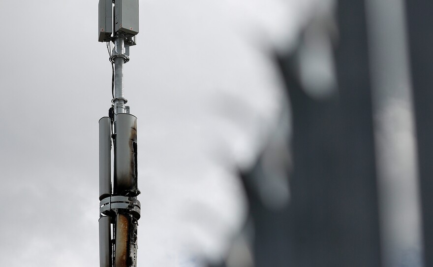 A fire-damaged telecom tower stands in Birmingham, England, in April. Authorities have cited conspiracy theories about 5G and the coronavirus as a possible motivation for a rash of such fires in the U.K.
