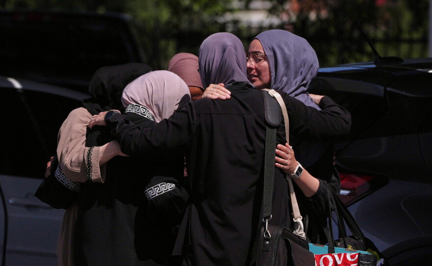 People embrace outside of the Islamic Center of San Diego on May 19.
