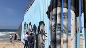 Volunteers work on the Playas de Tijuana Mural Project in this photo taken October 16, 2019.  