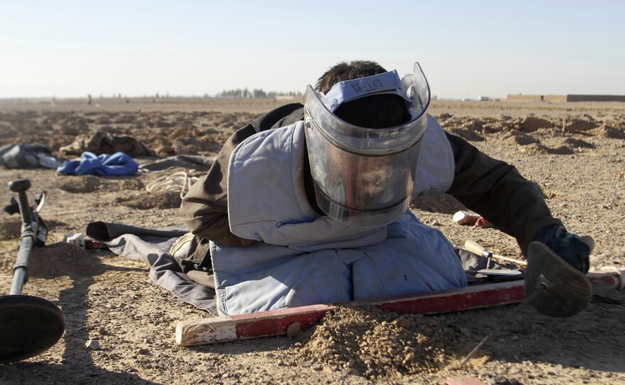 An Afghan worker searches for land mines in the Zhari district of Kandahar province in southern Afghanistan on Jan. 9.