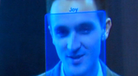 A blue box signifying a joyful expression is superimposed on an image of KPBS reporter David Wagner's face by the Emotient software. 