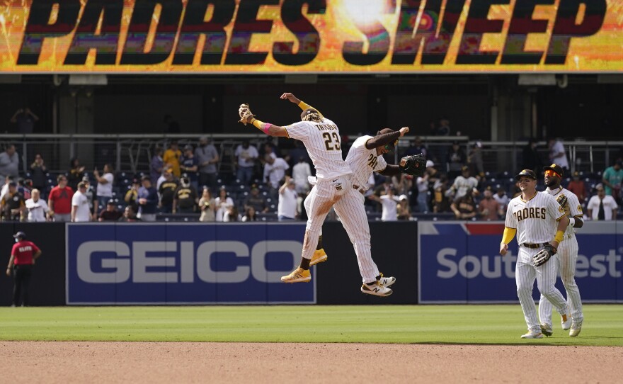 San Diego Padres shortstop Fernando Tatis Jr., left, celebrates with teammate center fielder Trent Grisham after the Padres defeated the Colorado Rockies 3-0 in a baseball game Wednesday, May 19, 2021, in San Diego.