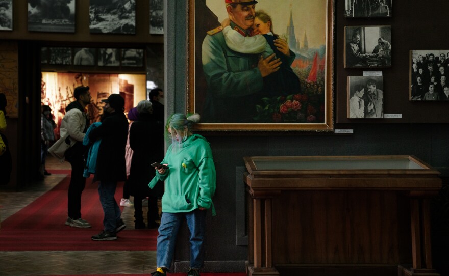 A person stands in front of a painting in the Stalin museum in Gori.