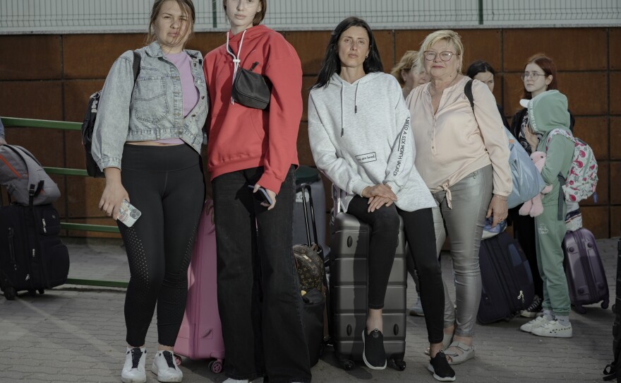 Snizhana Khomenko, Veronica Naboka, Violetta Naboka and their friend wait to cross the border.