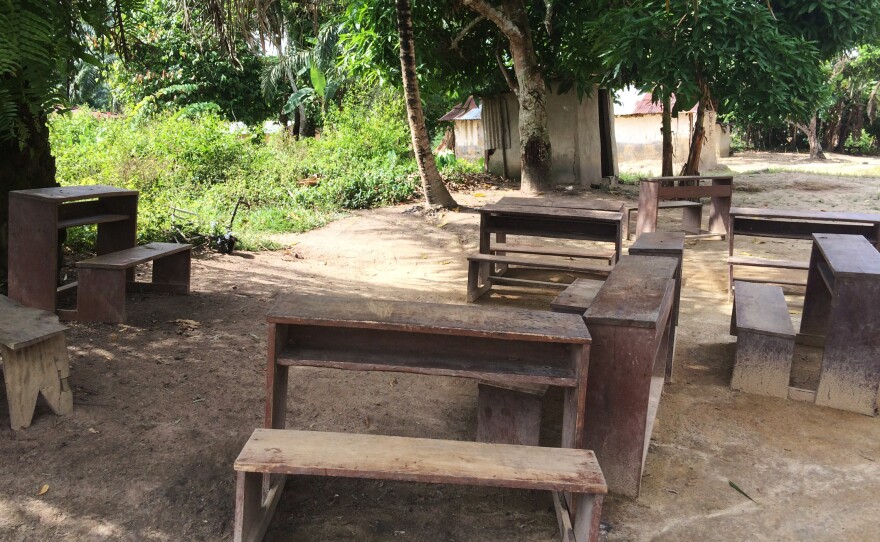 Wooden benches sit at the spot where Stanley's son died after his battle with Ebola.