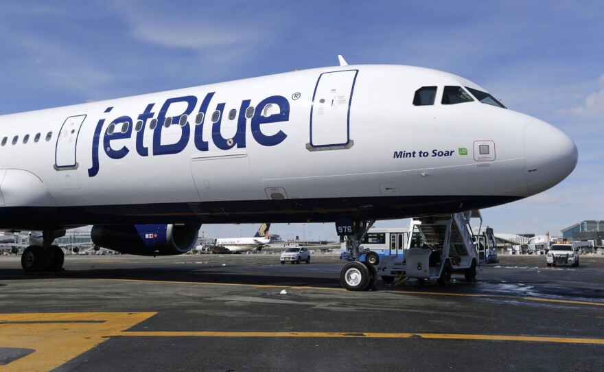 A JetBlue plane is shown at John F. Kennedy International Airport in New York on March 16, 2017. A federal judge has blocked JetBlue Airways from buying Spirit Airlines, saying the $3.8 billion deal would reduce competition.