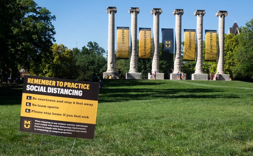 A sign on the Francis Quadrangle at the University of Missouri in Columbia reminds students to maintain social distancing.