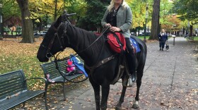 Shawna Cox, one of seven defendants and the only one not currently detained, rides Lady Liberty outside the federal courthouse in Portland on Tuesday.
