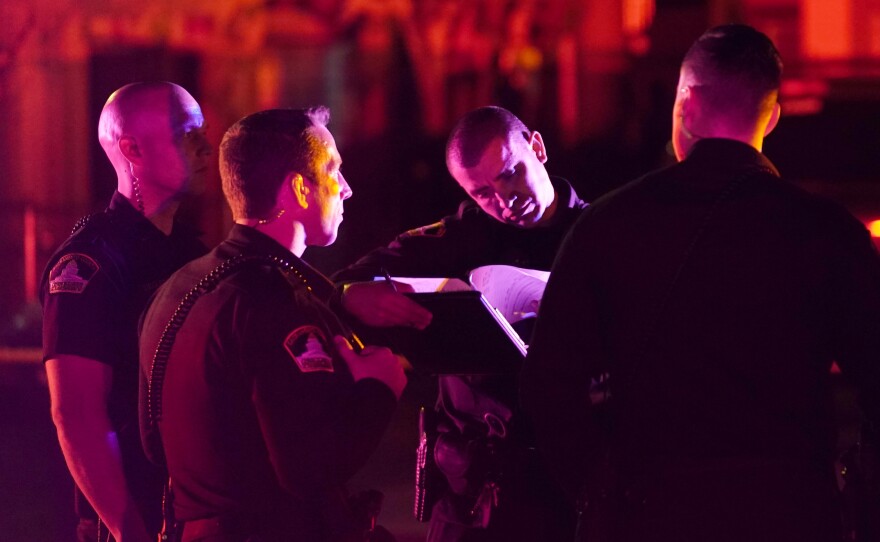 Sacramento County Sheriff's deputies gather outside the scene where a man shot and killed his three daughters, their chaperone and himself during a supervised visit with the girls at a church in Sacramento, Calif., Monday, Feb. 28, 2022.