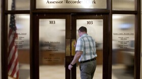 A man walks into the San Diego County's Assessor and Recorder office in the County Administration Building.