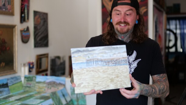 Skateboarder and artist Hunter Knolmayer holds up one of his paintings on Feb. 15, 2026.