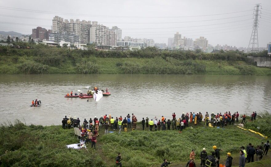 Rescue teams work to free people Wednesday from a TransAsia Airways ATR 72-600 turboprop airplane that crashed into the Keelung River shortly after takeoff from Taipei Songshan airport in Taipei, Taiwan.