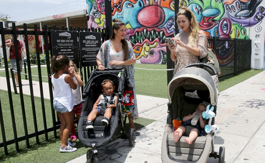 Vanessa Gomez (left) with her son Ezra, 2, and her friend Cristy Fernandez with her 9-month-old-son River, in the Wynwood neighborhood of Miami. At least 14 people likely caught Zika from mosquitoes in the neighborhood, health officials say. Gomez calls that news "scary," but adds, "we cannot stop living our lives."