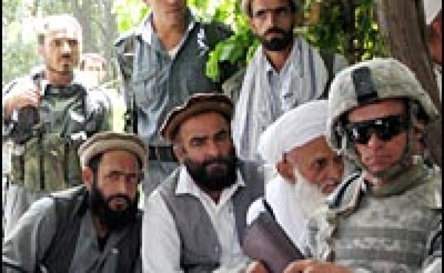 An Army National Guardsman sits with tribal elders and Afghan National Army soldiers at a local council meeting in Kapisa province.