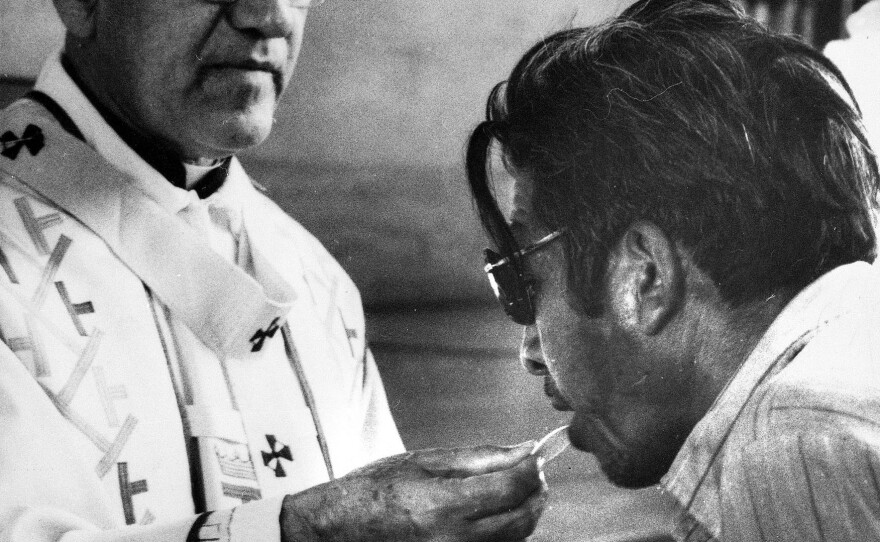Archbishop Oscar Arnulfo-Romero offers the host wafer during the communion rite to a member of the congregation during a church mass in San Salvador, El Salvador on Jan. 13, 1980.