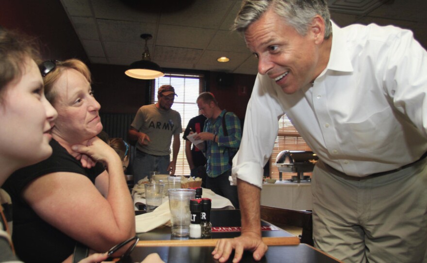 Huntsman, campaigning last month in the Granite State, speaks with Sara Brothers (left) and Rebecca Brothers at the Barley House restaurant in Concord.
