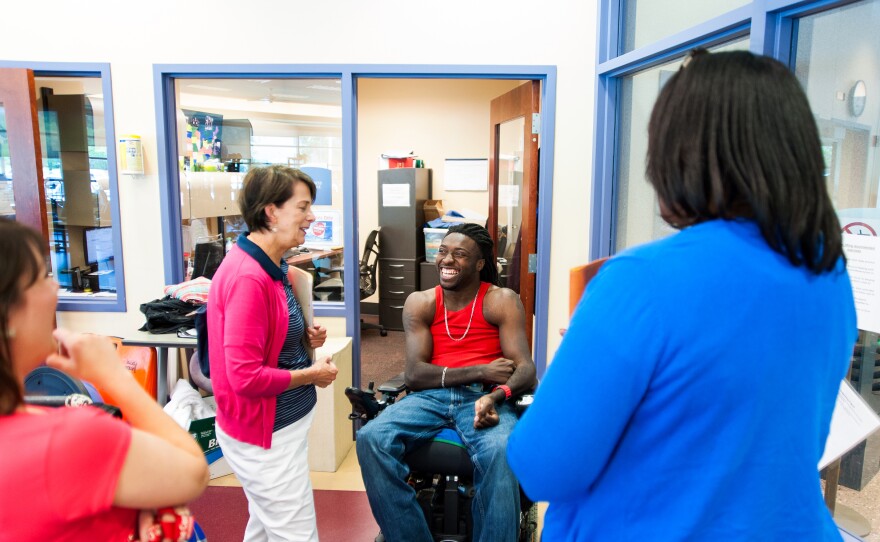 Just as Nnaka gets ready for his daily workout at the center, visitors show up for a tour. He volunteers to show them the gym and other facilities.