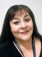 Woman smiling wearing a black shirt.