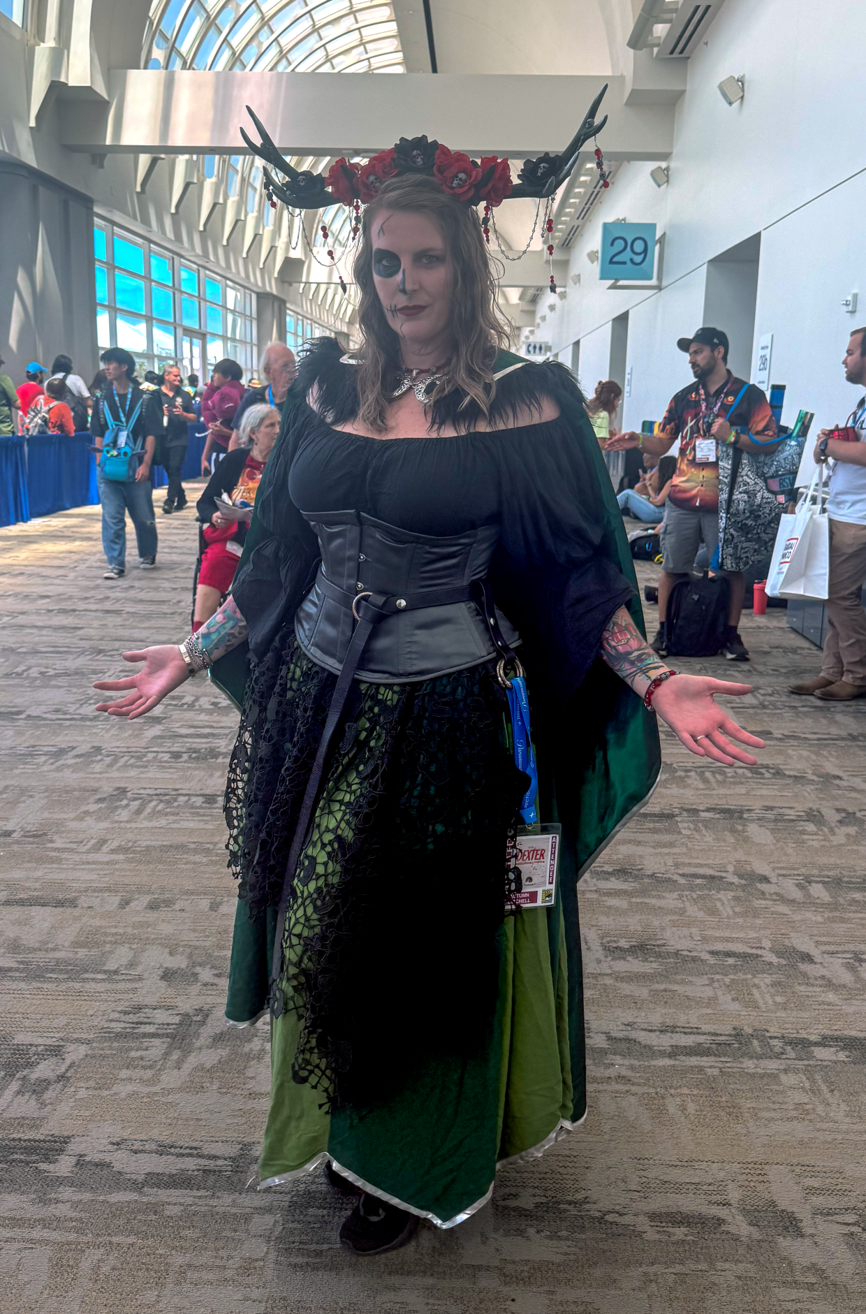 Autumn Mitchell cosplays as Hel from the romantasy book "A Curse Carved in Bone" by Danielle L. Jensen at Comic-Con on July 24, 2025. The character is drawn from Norse mythology and is "depicted as being half dead and decaying, and half still beautiful and alive," Mitchell said.