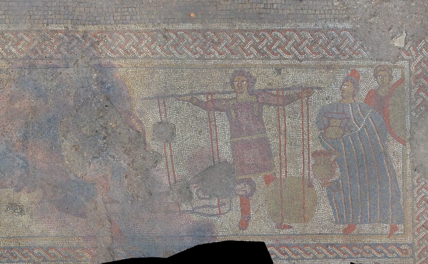 A panel of the mosaic discovered by a team of archaeologists in England. The researchers say it shows the body of Hector returning to his father, King Priam (right), in exchange for his weight in gold.