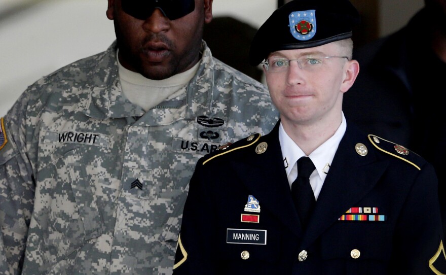 Army Pfc. Bradley Manning (right) is escorted out of a courthouse in Fort Meade, Md., on June 25, 2012. His attorney announced that Manning, who is accused of leaking classified information to WikiLeaks, had agreed to plead guilty to lesser charges.