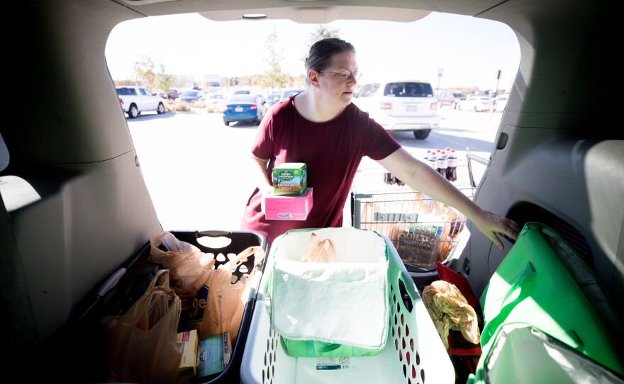 Smith loads an Instacart customer's groceries in the back of her van. "I actually love grocery shopping," she says. "The only thing I'm asking for is to be paid fairly."