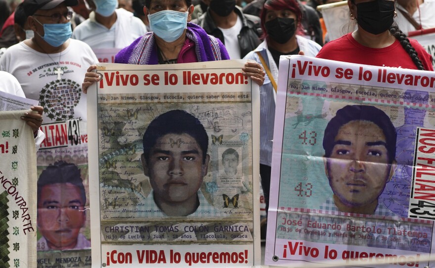 Family members and friends march seeking justice for the missing 43 Ayotzinapa students in Mexico City, Aug. 26, 2022.