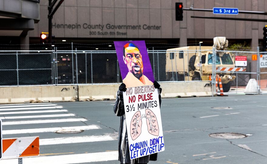 A lone protester outside the Hennepin County Courthouse on Monday as lawyers presented closing arguments in the murder trial of Derek Chauvin. The jury is now deliberating.