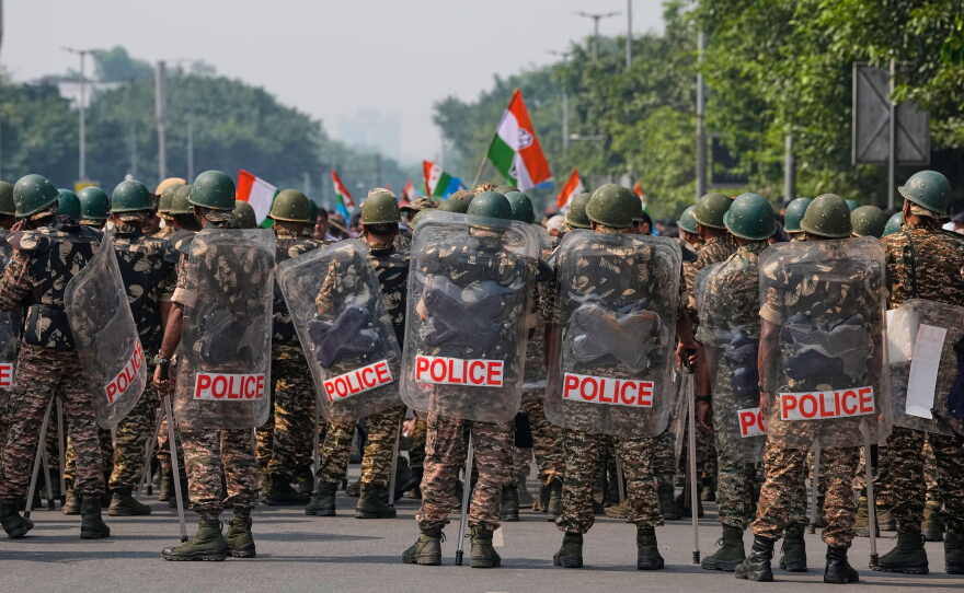 Security personnel in riot gear arrive to escort workers of India's opposition Congress party as they gather for a march toward the Supreme Court demanding the resignation of Chief Election Commissioner Gyanesh Kumar in New Delhi, India, on Monday.