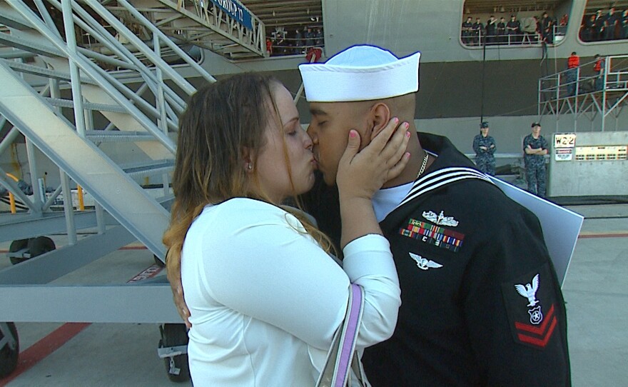 Marcus and Alexis Plair kiss after Marcus leaves the USS Theodore Roosevelt after a deployment which began in March, Nov. 23, 2015.