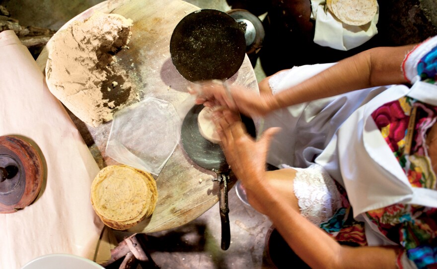 A woman prepares tortillas at Kinich Restaurant in Izamal,Yucatan, Mexico. The average Mexican consumes 135 pounds of tortillas per year.