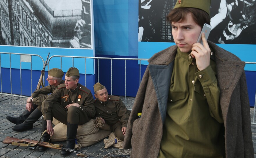 Actors dressed as World War II Soviet Red Army soldiers take a break during rehearsals Thursday at Red Square ahead of Saturday's celebrations.