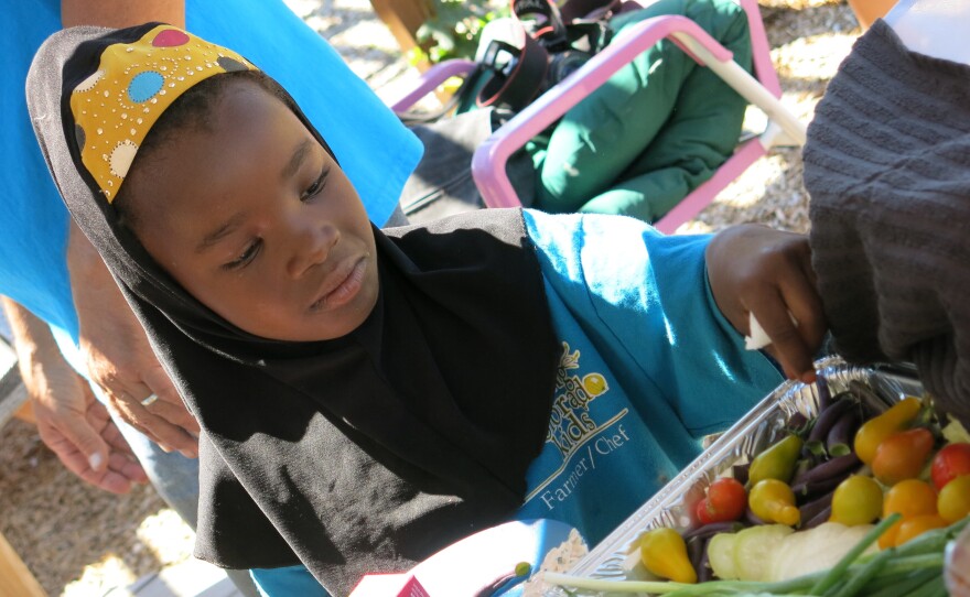Second-grader Kadija Noor's family came to the U.S. from Somalia. She says being a part of Growing Colorado Kids has led her to eat more healthful foods, although she still prefers the garden's strawberries to its vegetables.
