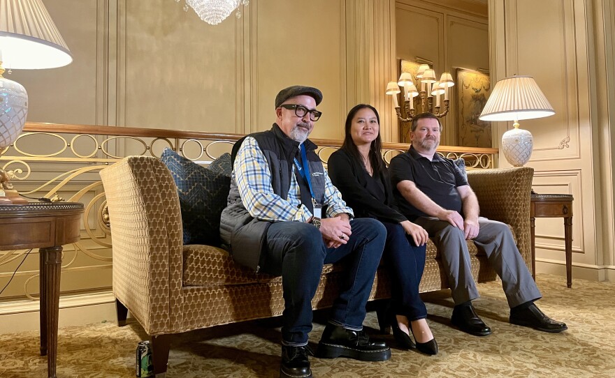 City and county employees Guy Langman, Giang Meyers, Steve Lockett sit on a couch inside the Westgate Hotel, Sept. 24, 2025.
