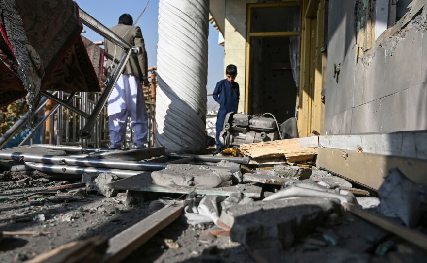 Residents inspect a damaged house after several rockets landed Saturday in Afghanistan's capital, Kabul. The Islamic State claimed responsibility for the attack, which comes the same day as U.S. Secretary of State Mike Pompeo's meeting with Taliban leaders in Qatar.