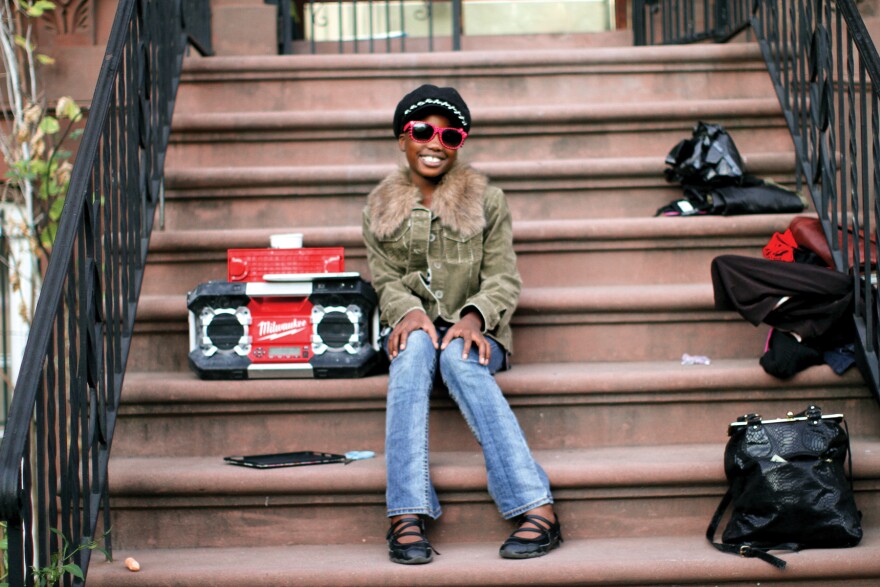 "When I walked by," Stanton writes in his book, "she was really moving to the music — hands up, head nodding, shoulders swinging. I really wanted to take her photo, so I walked up to the nearest adult and asked: 'Does she belong to you?' Suddenly the music stopped, and I heard: 'I belong to myself!' "