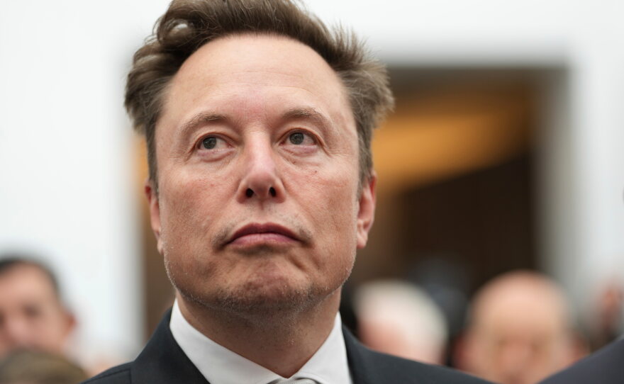 Elon Musk listens as President Donald Trump speaks during an event at the U.S. Institute of Peace, Oct. 8, 2026, in Washington.