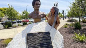 Fredrika Newton stands next the bust of her late husband, Black Panther co-founder Huey P. Newton. NPS is considering a Black Panther Party National Historical Park.