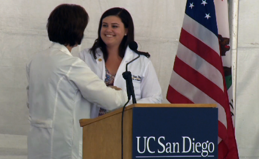 A student is welcomed to UC San Diego School of Medicine in the traditional "white coat" ceremony, Friday, Sept. 4, 2015.