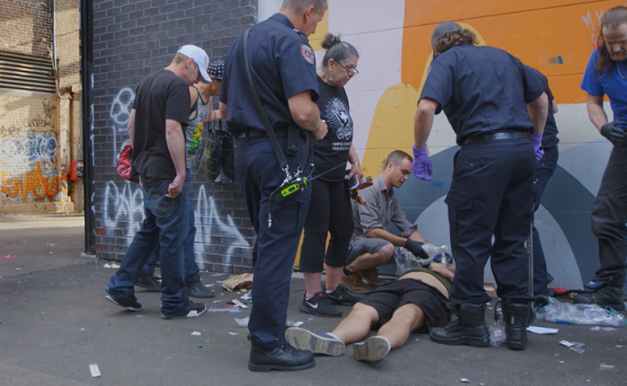 Medical staff helping victim of an overdose. 