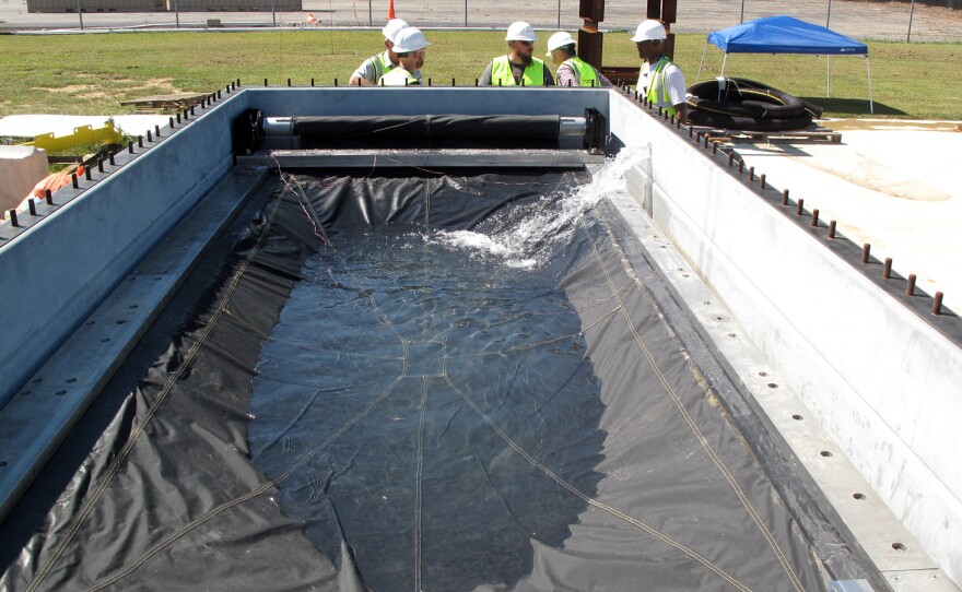 Engineers test the Flex-Gate, a big sheet of waterproof fabric designed to cover subway entrances and keep water out. Its creation was inspired in part by roll-up metal doors used to cover store entrances.