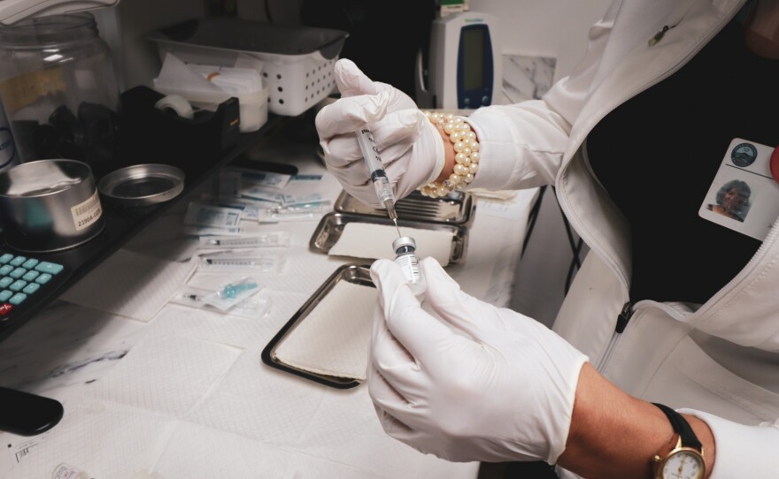 An employee of the Imperial County Public Health Department prepares to administer the COVID-19 vaccine on Dec. 18, 2020. Imperial County, Calif.